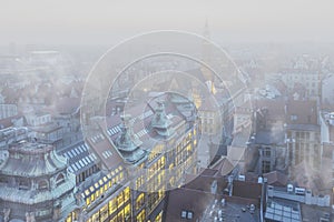Thick layer of smog and haze obscuring the view of buildings. Heavy smog over the city during winter in Wroclaw, Poland photo